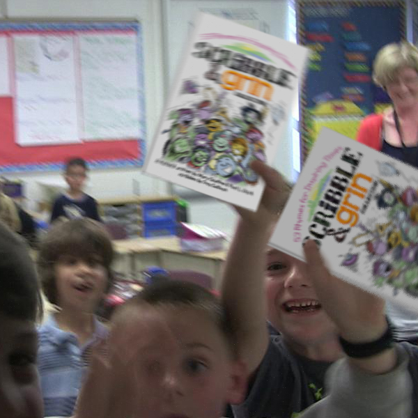 Photo of Kids in classroom holding Scribble & Grin books